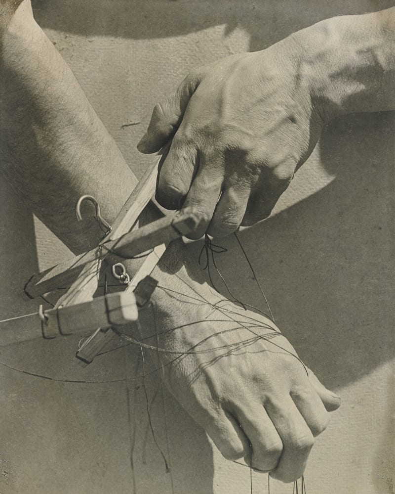 Puppeteer's hands with string.