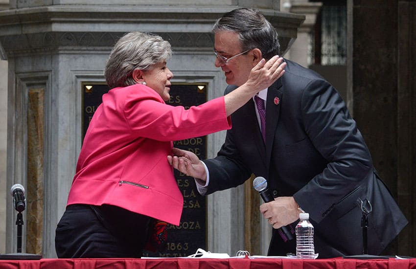 Mexico's new foreign minister, left, Alicia Barcena, greets outgoing foreign minister Marcelo Ebrard