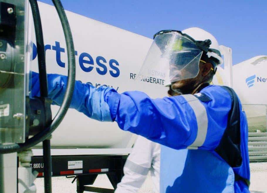 man standing next to natural gas trucks