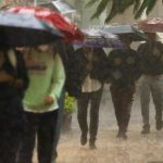 People walking in heavy rains in Mexico City