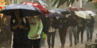 People walking in heavy rains in Mexico City