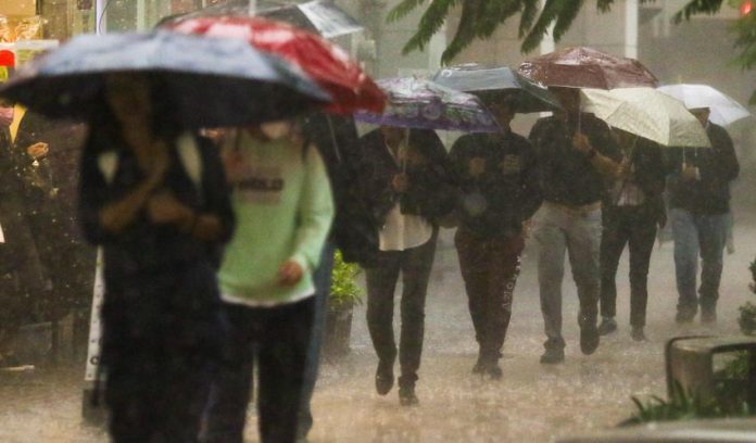 People walking in heavy rains in Mexico City
