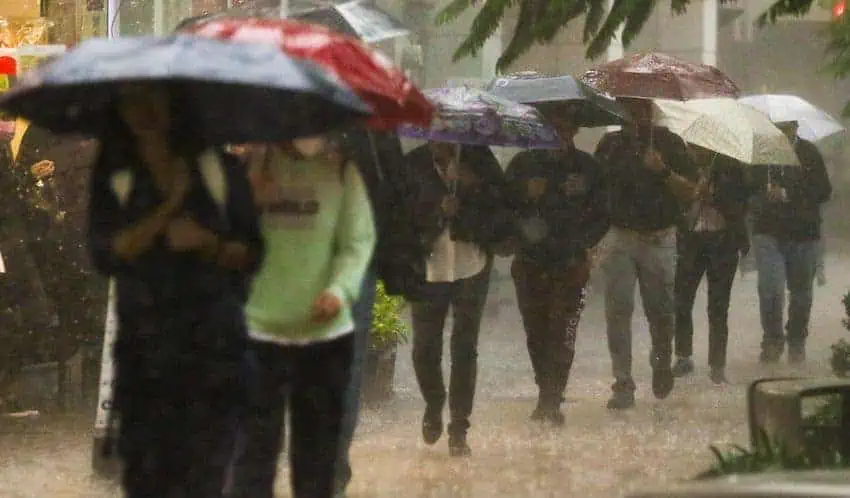 People walking in heavy rains in Mexico City