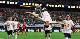 Soccer player Orbelín Pineda doing a backflip on the pitch