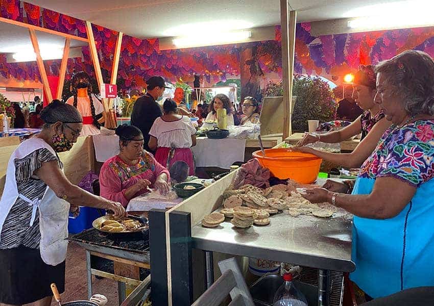 Mexican women preparing food at 2023 Guelaguetza