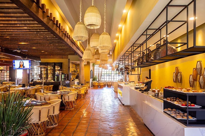 A high-end restaurant in Mexico with white table cloths and warm lighting, representing the service sector.
