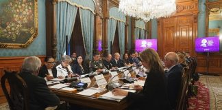 AMLO and US and Mexican officials sitting at a table in the National Palace.