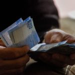 Man holding Mexican pesos