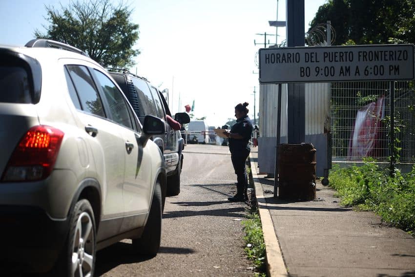 An immigration agent checks cars at Mexico's border with Guatemala, representing an issue discussed at the US presidential debate.