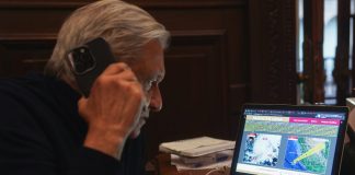 AMLO on the phone viewing hurricane data