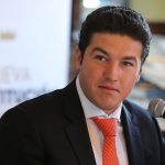 A portrait of a light skinned man in a suit