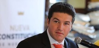 A portrait of a light skinned man in a suit