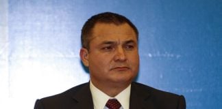 Former Mexican official Genaro García Luna stands at a microphone