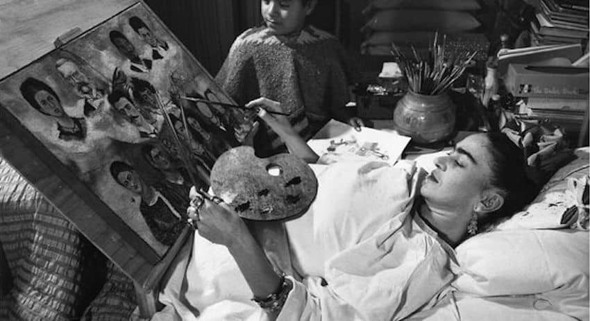 Frida Kahlo painting a portrait from bed