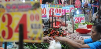 Price labels above produce in a Mexican market