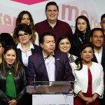 A group of politicians at a podium
