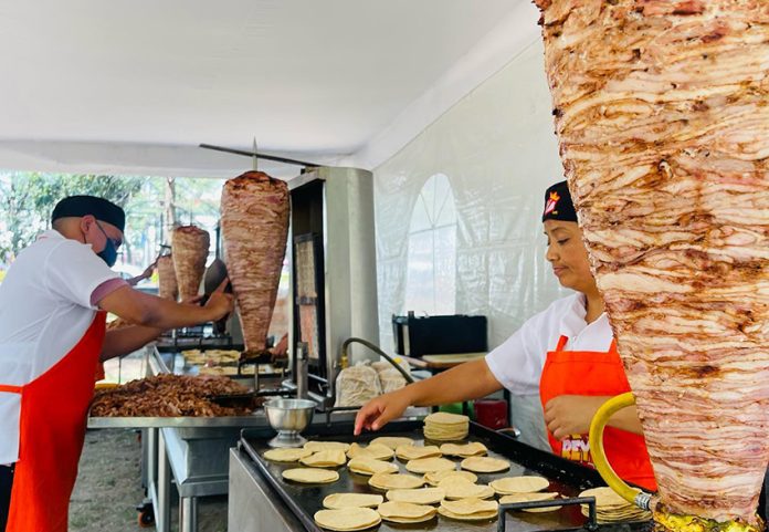 Taquería Don Rey employees prepare tacos al pastor