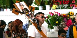 Man in a church with a cross