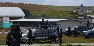 State police, army and National Guard troops stand guard in Texcapilla, three days after the violent clash of Dec. 8.
