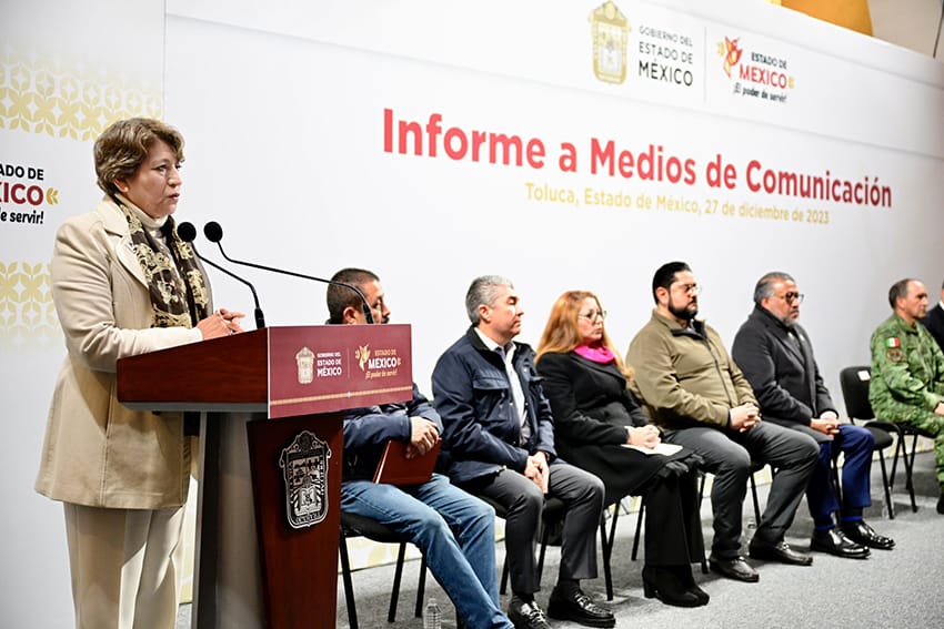 Delfina Gómez speaks at a podium while other officials listen