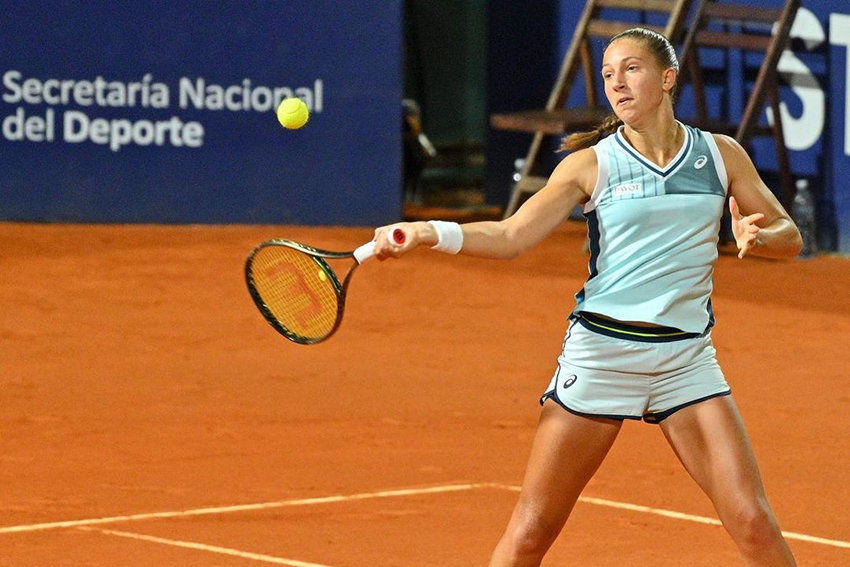 A woman hits a tennis ball