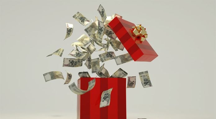 A red box full of Mexican pesos, representing thee holiday aguinaldo bonus