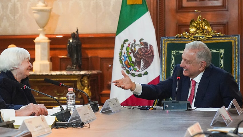 President López Obrador gestures towards Janet Yellen as both sit at a conference table.