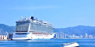 A cruise ship in Acapulco Bay with a sunken boat in the foreground