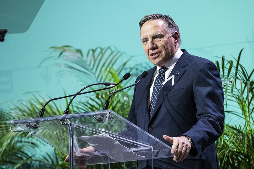 Francois Legault speaks at a podium