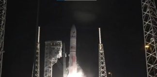 A rocket blasts off at night