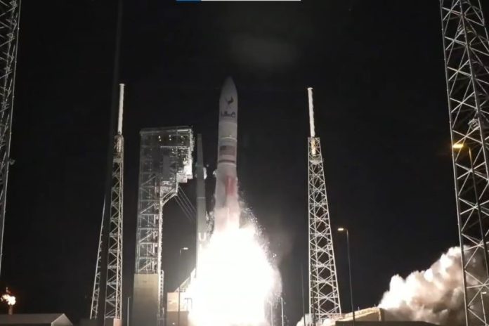 A rocket blasts off at night
