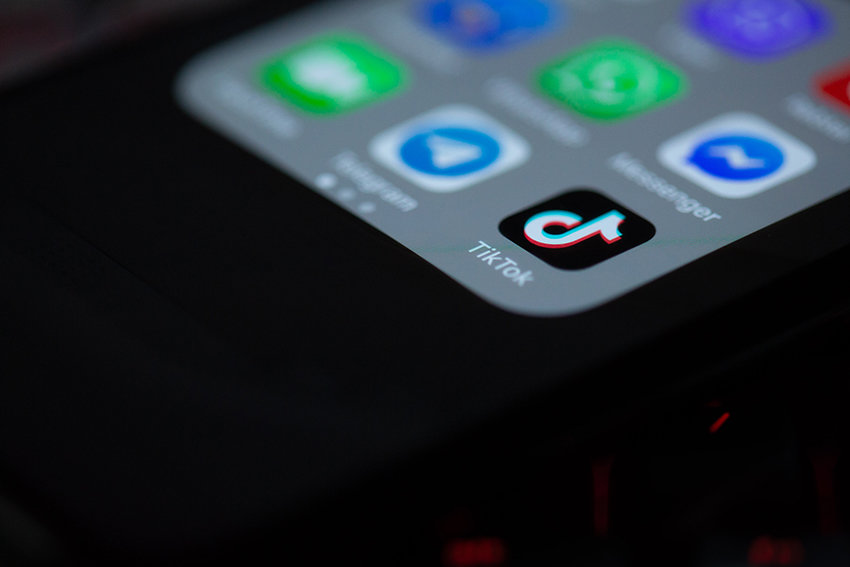 A phone screen with the TikTok app icon in focus