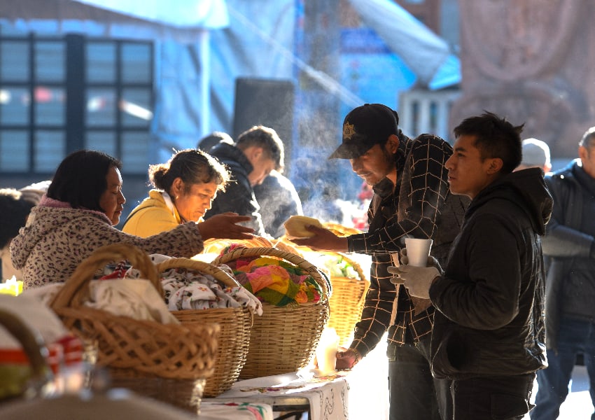 People buying tamales from vendors