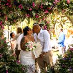 Couple getting married surrounded by large flower heart