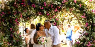 Couple getting married surrounded by large flower heart