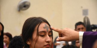 Woman receives a blessing and smudge of ash