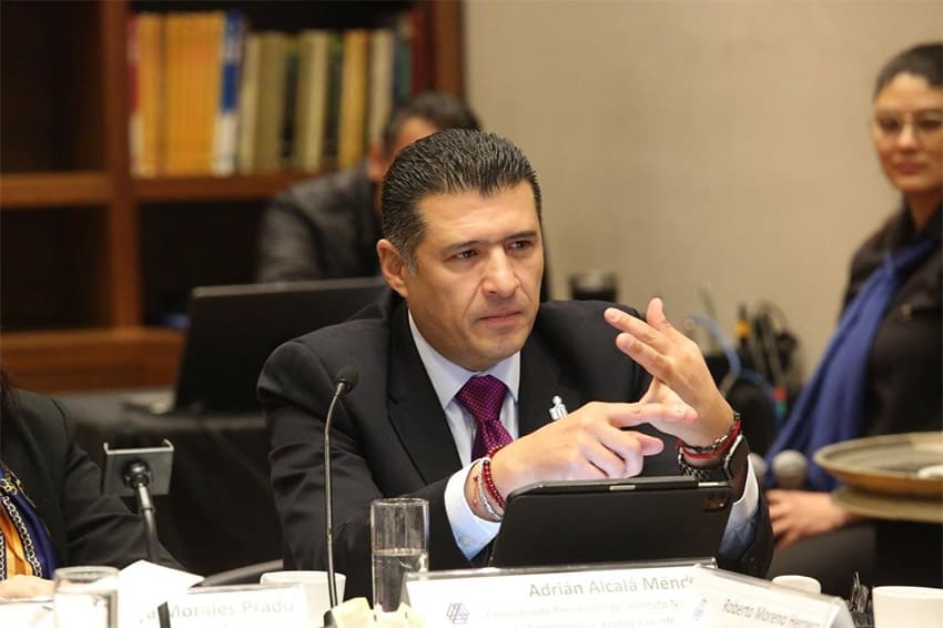 Adrián Alcalá sits at a meeting