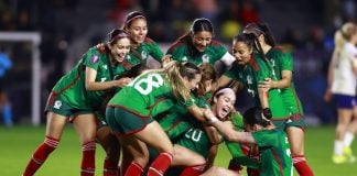 Women soccer players celebrate a win on the field