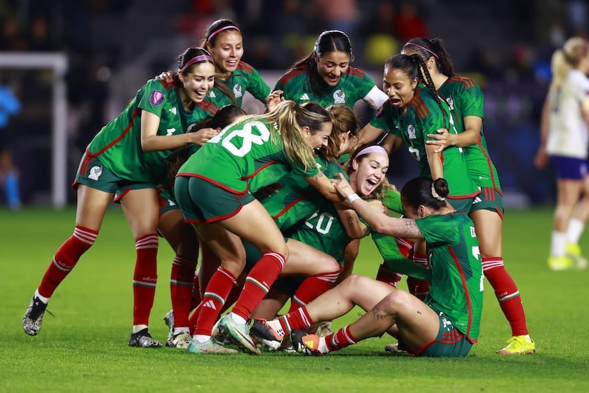 Women soccer players celebrate a win on the field