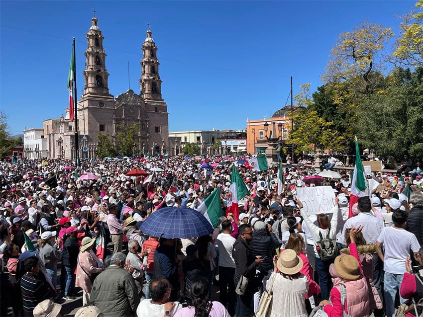 The square in front of the Aguascalientes city cathedral, filled with people waving Mexican flags