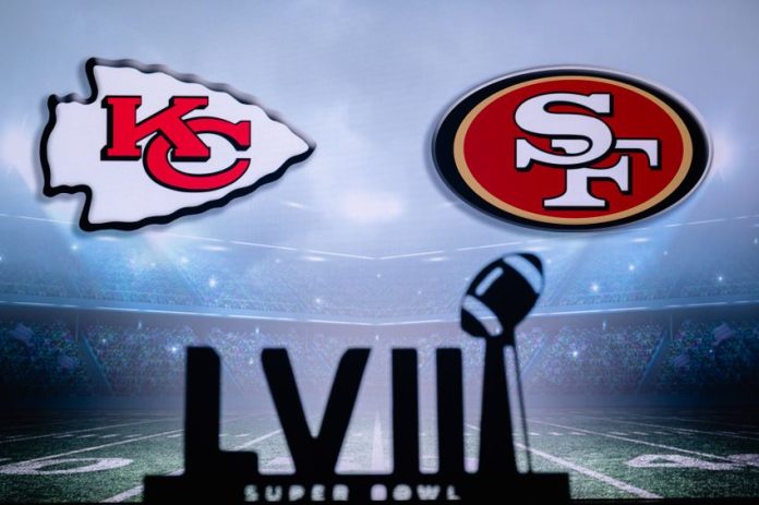 A TV screen shows the logos for the San Francisco and Kansas City NFL teams