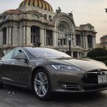 A Tesla vehicle drives past the Palacio de Bellas Artes in Mexico City