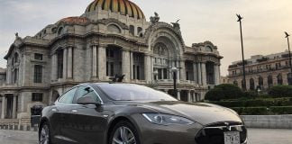 A Tesla vehicle drives past the Palacio de Bellas Artes in Mexico City