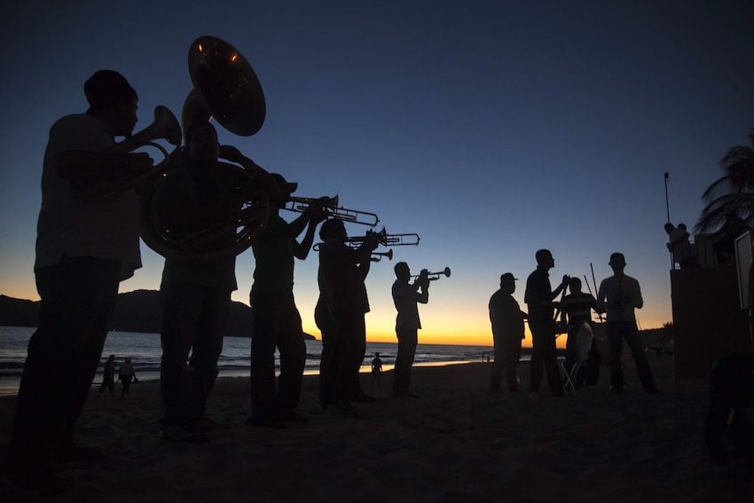 Banda musicians performing at sunset in Mazatlán