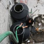 Water tanks being filled on a rooftop
