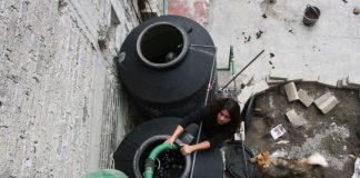 Water tanks being filled on a rooftop