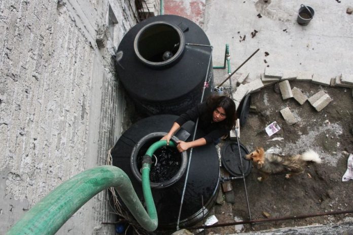 Water tanks being filled on a rooftop