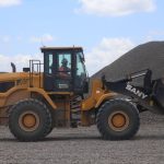 A front end loader moves ballast as it prepares a section of track for the Maya Train in Yucatán