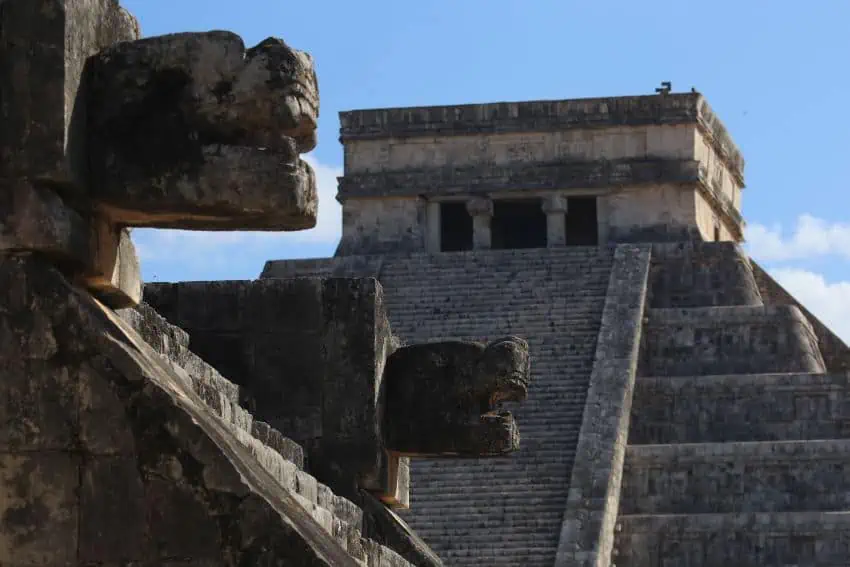 A photo of archeaological features at Chichén Itzá, with a pyramid in the background