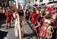 Jesus carries the cross, in a scene from the 2023 Iztapalapa Passion Play.